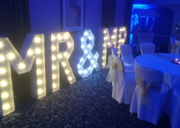 mr and mr light up vintage letters with blue uplighters at solent hotel and spa