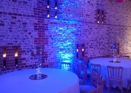 blue uplighters table centerpiece vase and mirror at upwaltham barns chichester